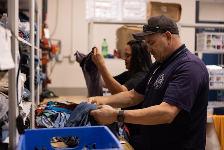Staff sorting clothing in the Resource Center Staff sorting clothing in the Resource Center