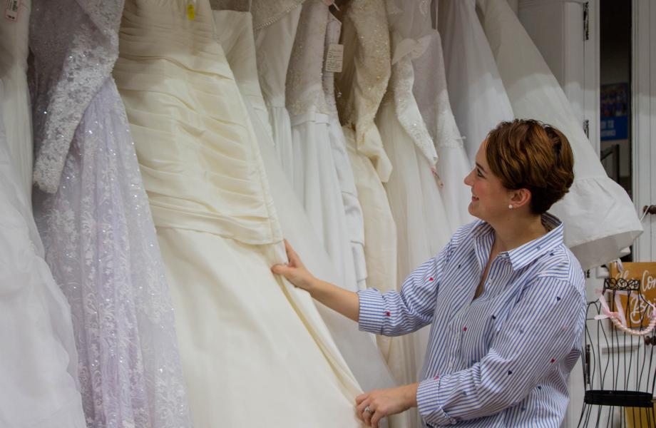 Mackenzie sorting through wedding dresses
