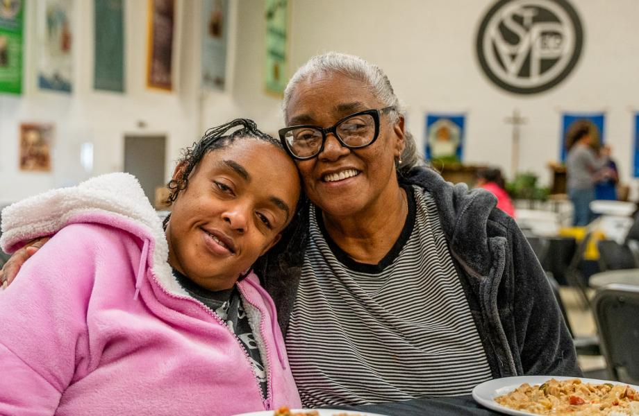 Kenya and Shay enjoy a meal at SVdP's Family Evening Meal.