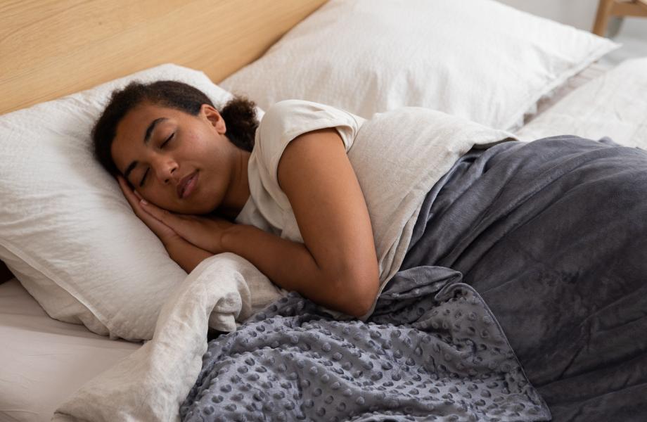 A woman sleeps in her bed.