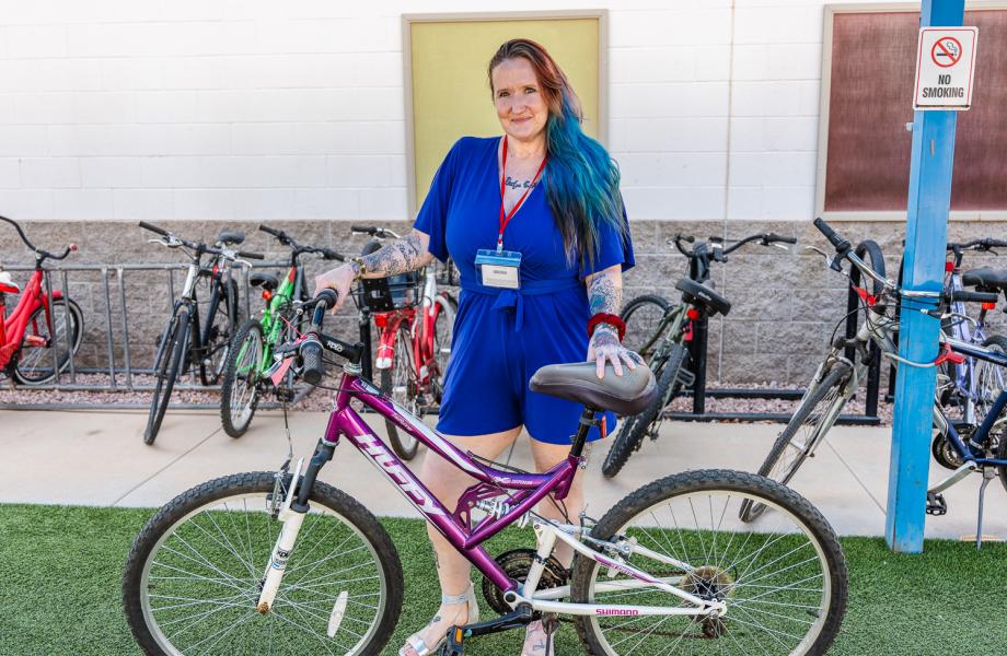 Alinda Nelson poses with her bike outside of Ozanam Manor.
