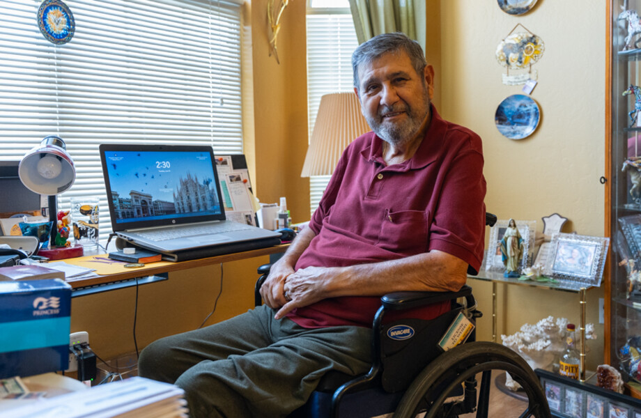 Joseph Granio sits in his living room.