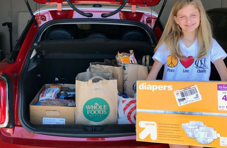 Lauren proudly displays the donations she and her mother Anne helped collect.