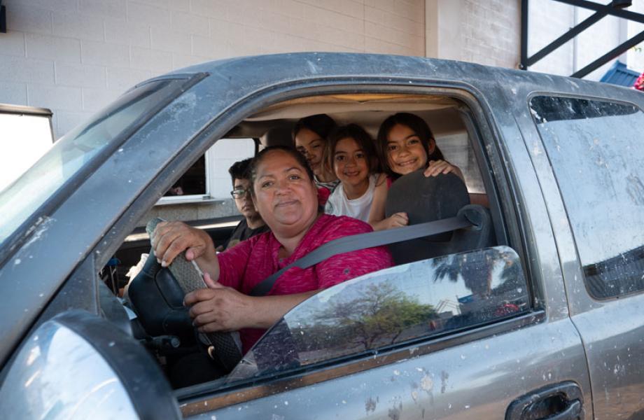 Rosa Guzman and the kids smile after going through the Family Dining Room drive-thru.