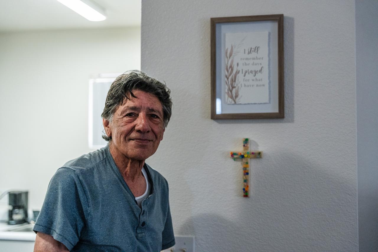 Mando stands next to his cross.