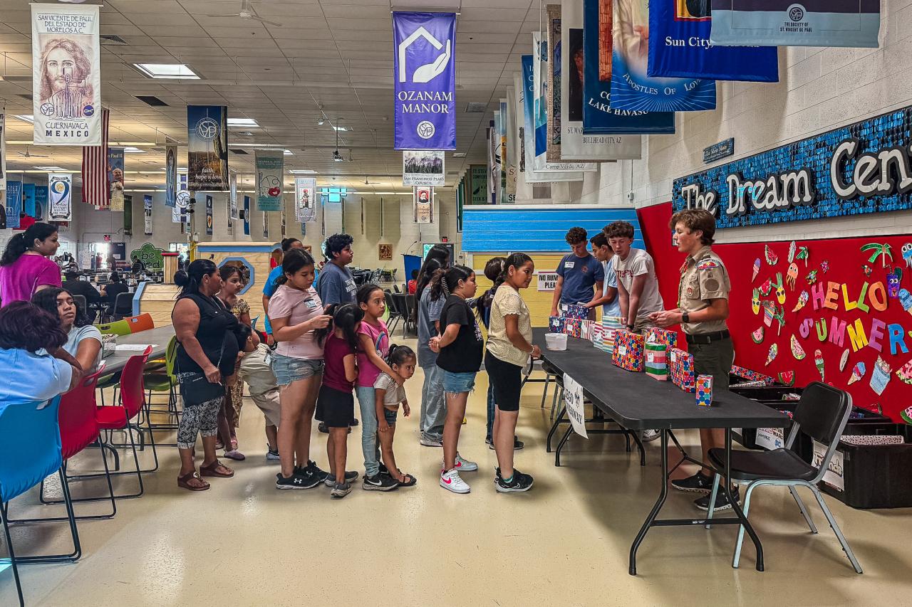 A line of kids waits to pick a Lego set from Wilder's collection.