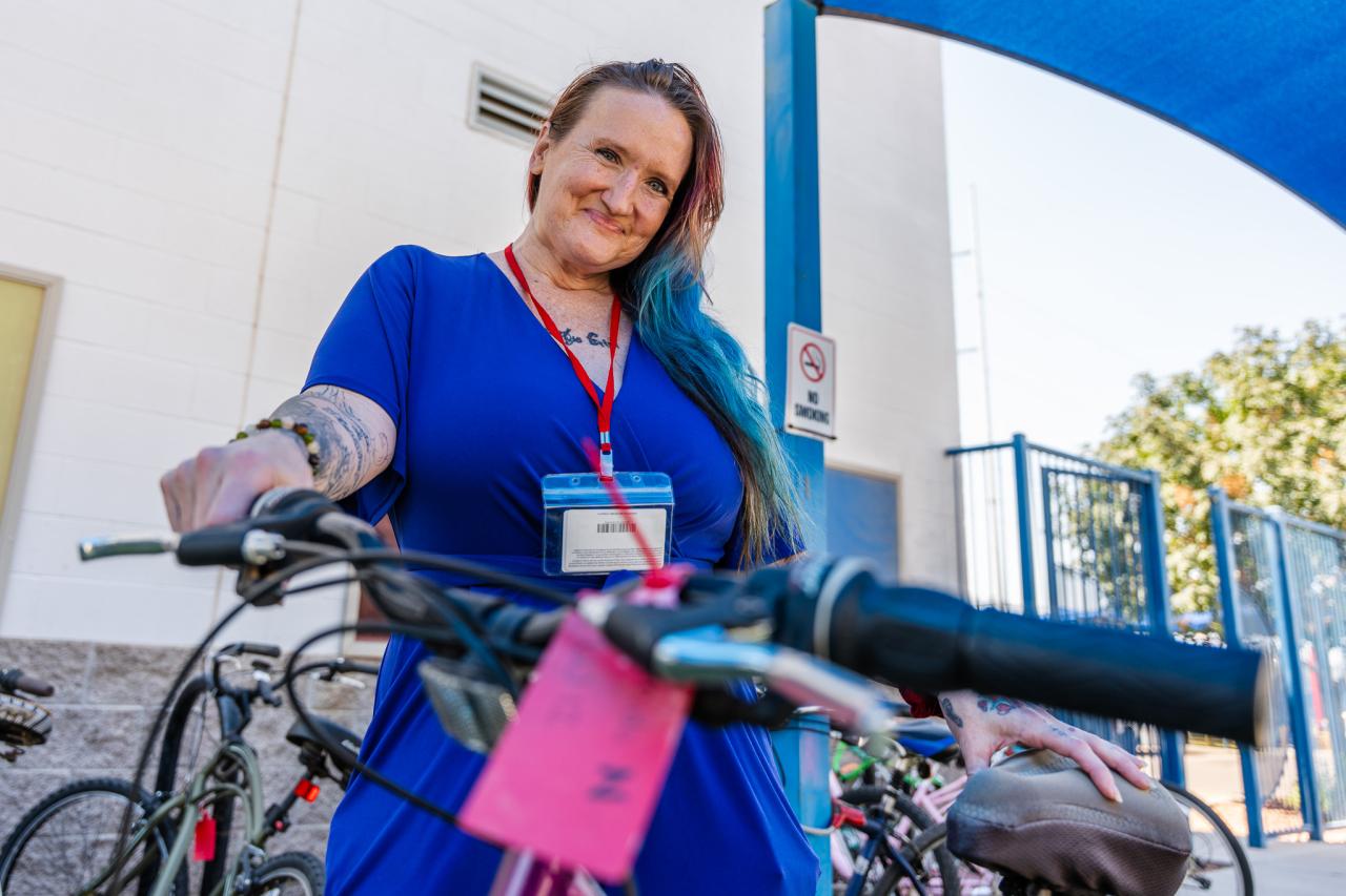 Alinda poses with her bike outside of Rosalie's Place.