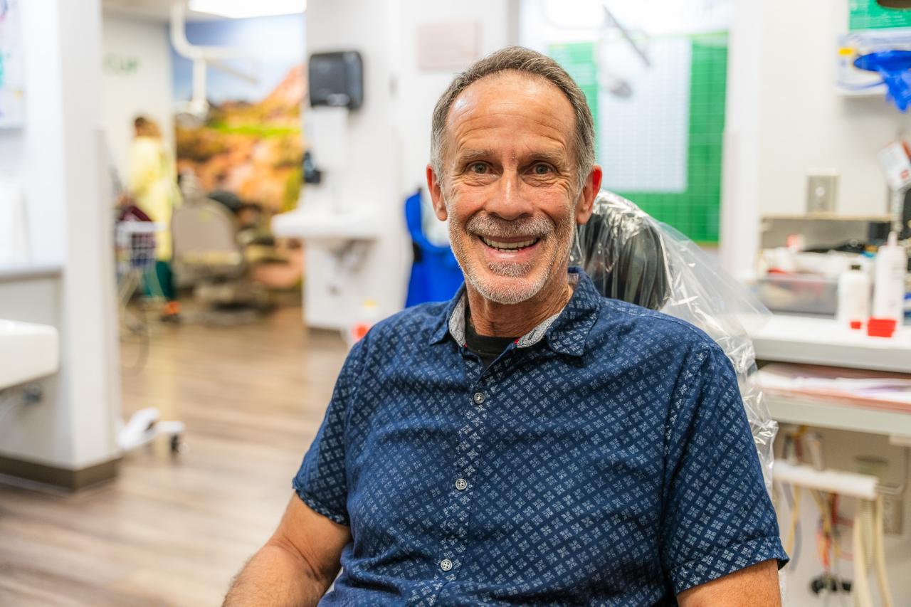 Anthony sits in a dental chair in the SVdP Dental Clinic.
