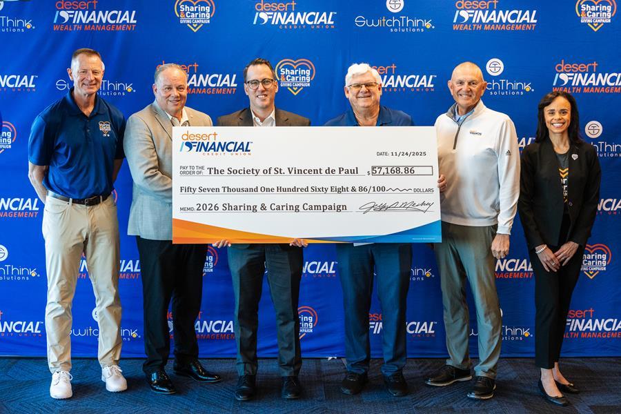 Leadership from Desert Financial presents a check to SVdP's Ryan Corry.