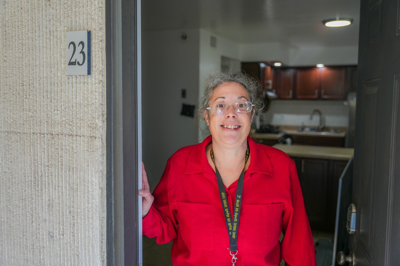 Carmela poses in the doorway of her apartment. 